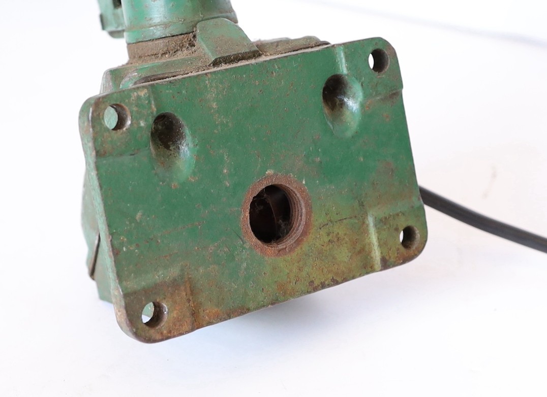 A green painted and enamelled metal adjustable workbench lamp, height 37cm to the bend